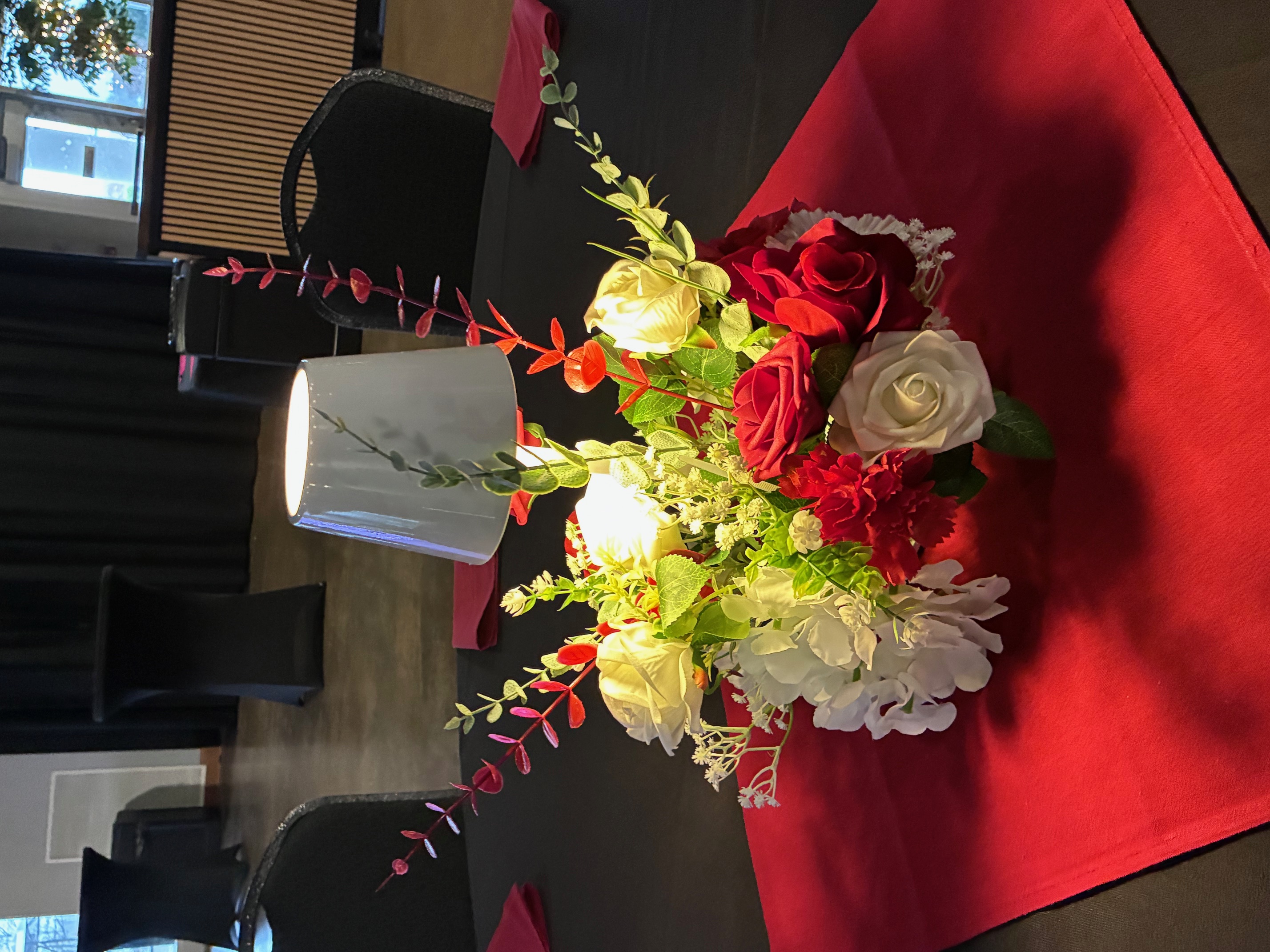 Red and white floral centerpiece with lamp